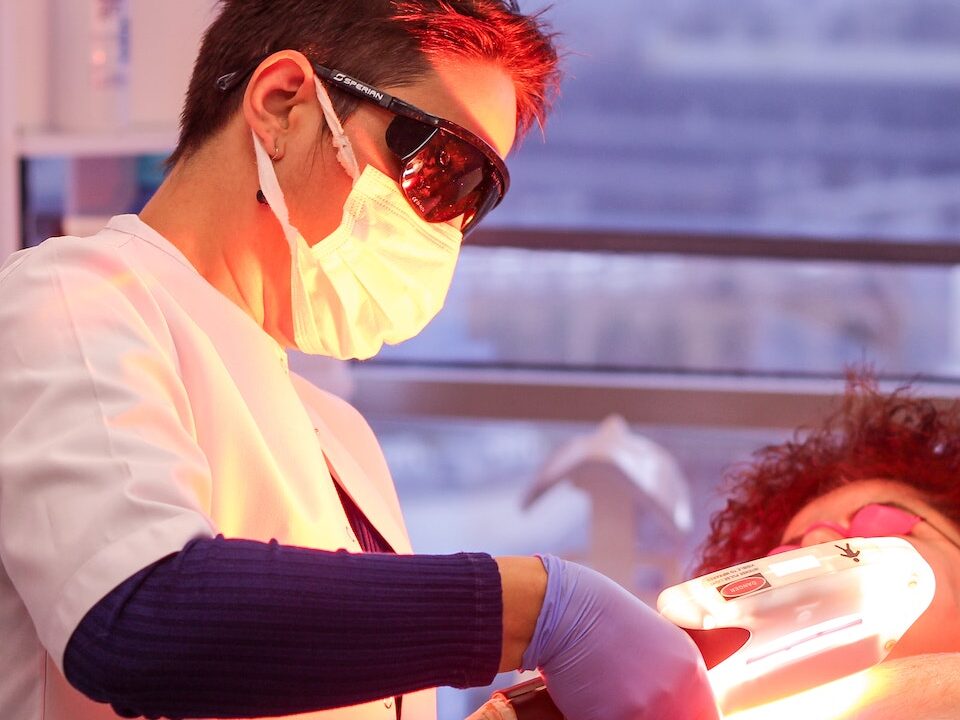 Woman Giving Laser Treatment