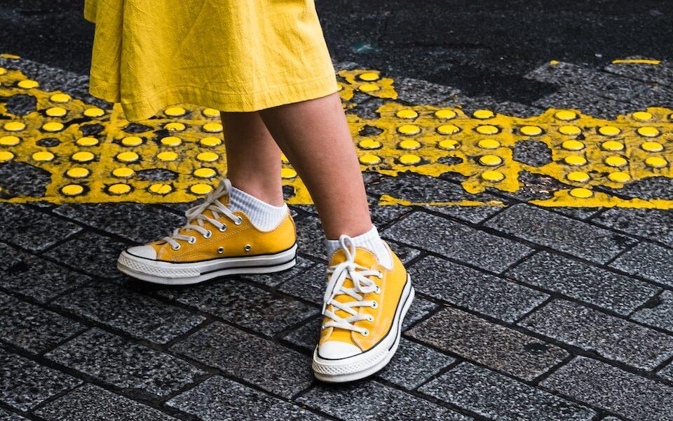 person wearing yellow maxi dress and yellow Converse low-top sneaker